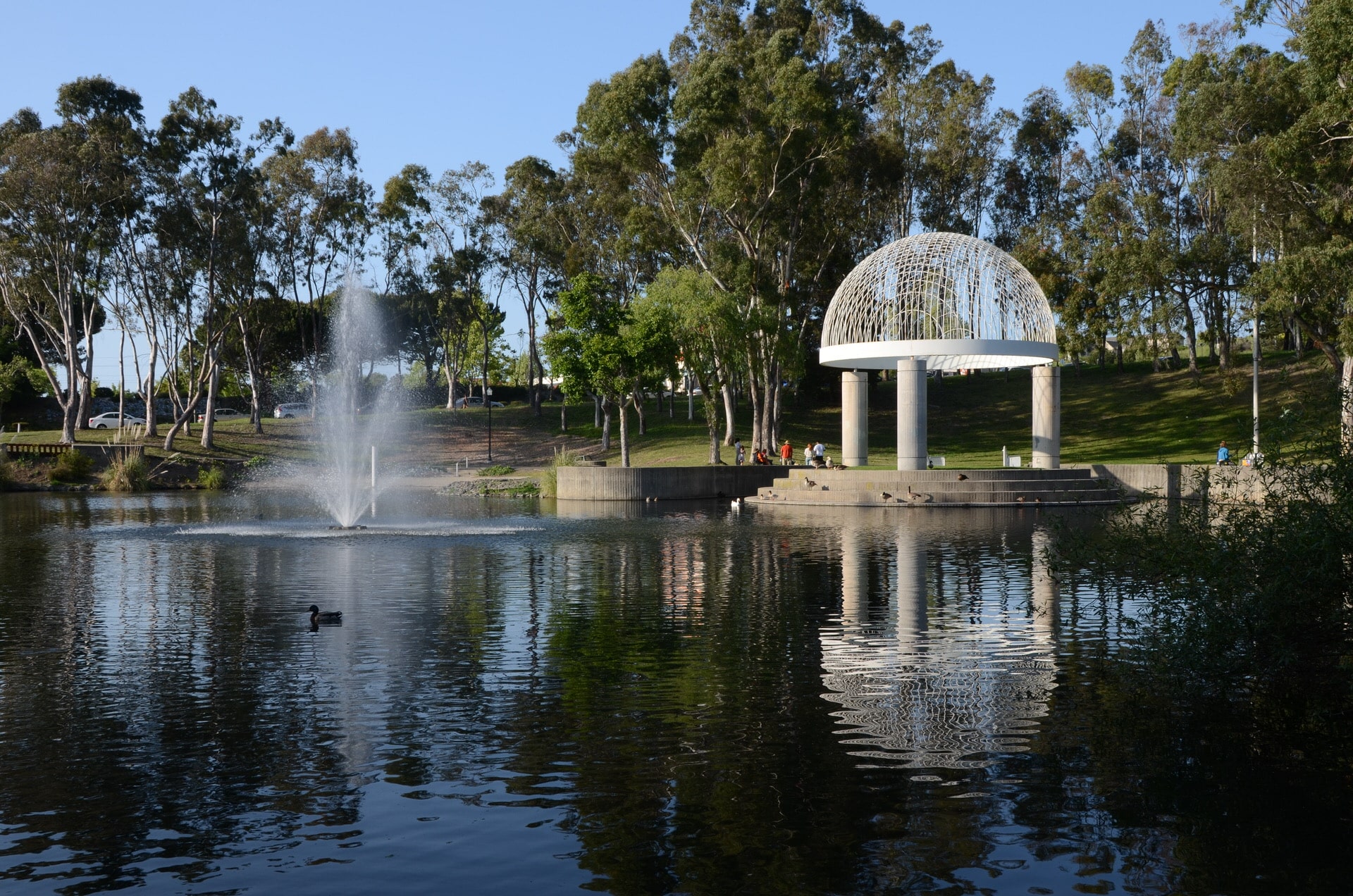 a fountain in a pond with a dome shaped structure